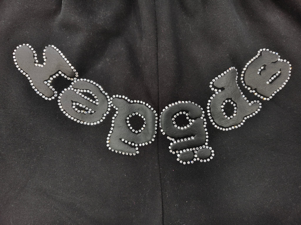 black Sp5der shorts feature a rhinestone-embellished logo and a spider web graphic