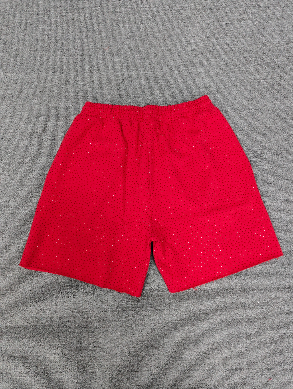 Sp5der rhinestone graphic shorts featuring a black arched logo across the front