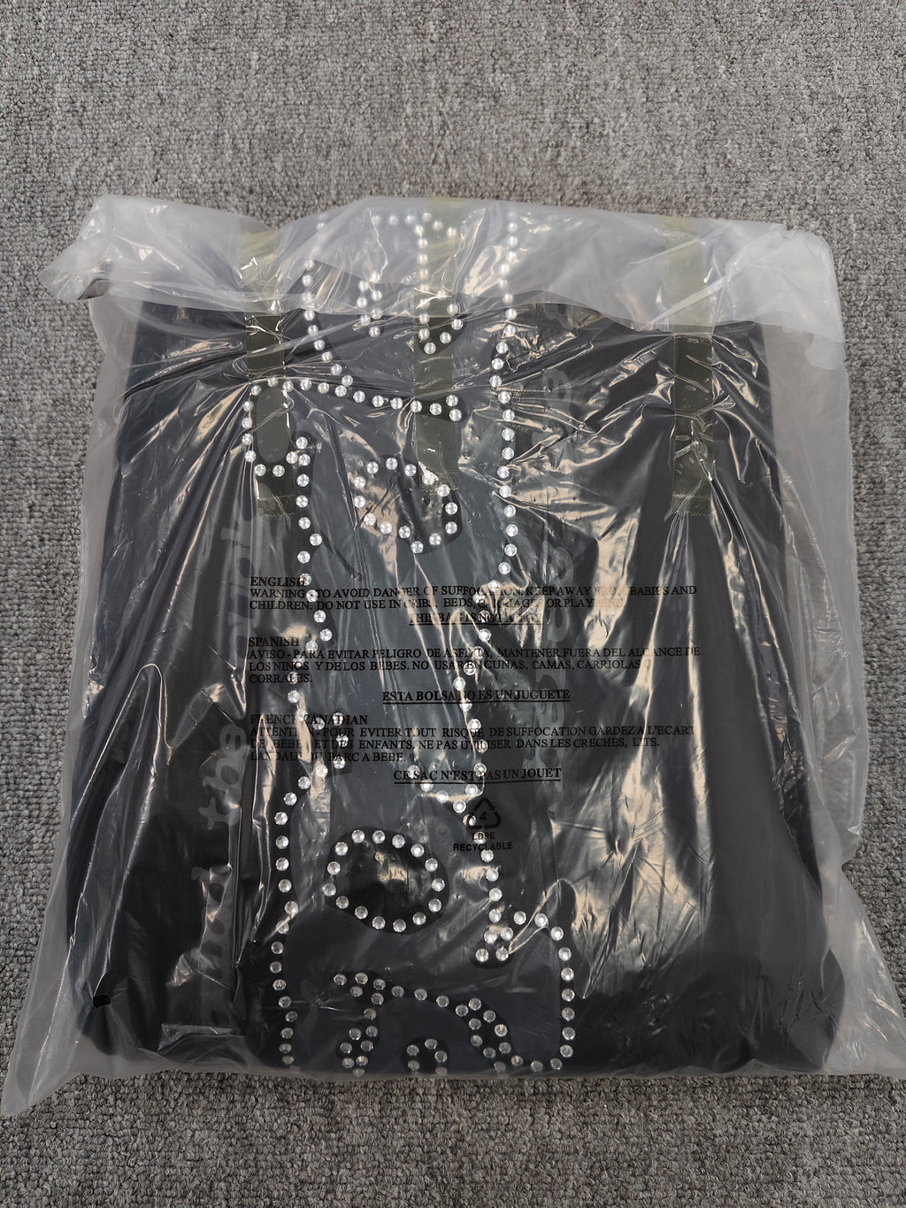 black SP5DER Rhinestone Punk V2 track pants feature rhinestone star embellishments and a rhinestone-encrusted logo