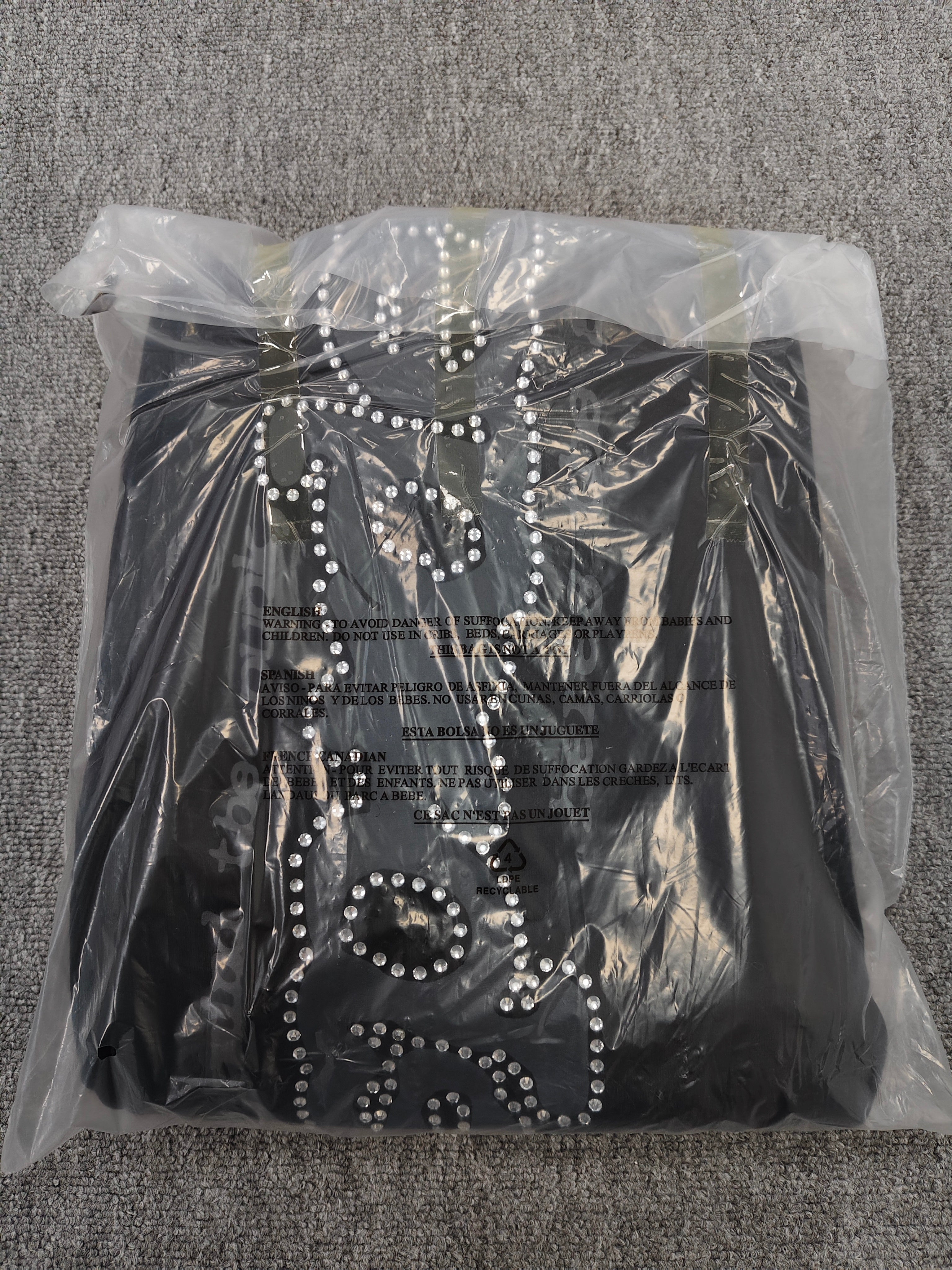 black SP5DER Rhinestone Punk V2 track pants feature rhinestone star embellishments and a rhinestone-encrusted logo