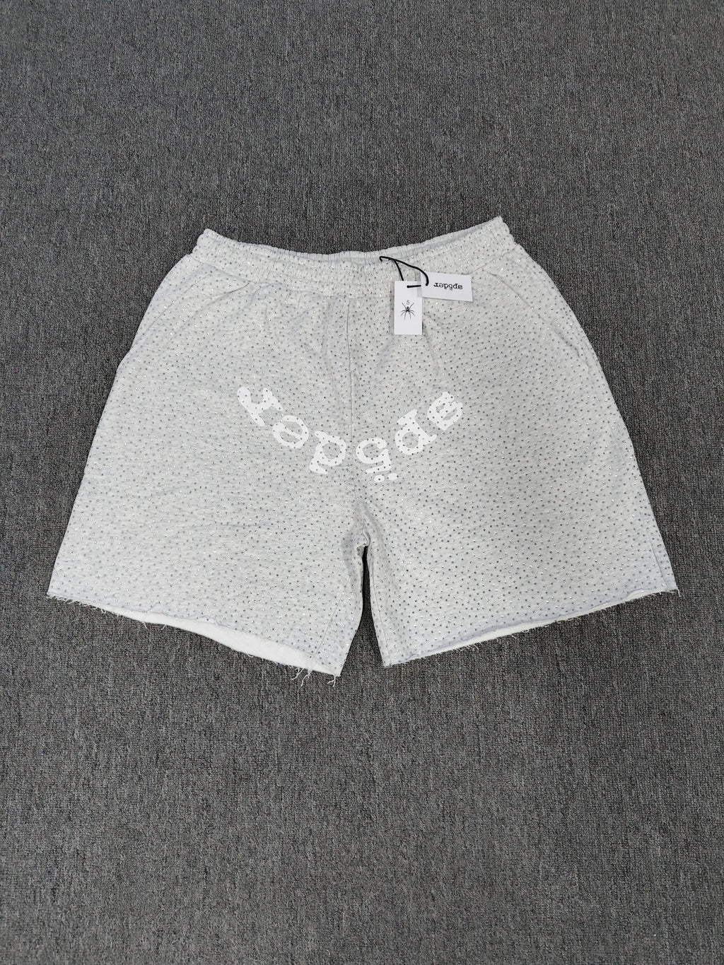 Sp5der VVS sweatshorts in heather grey feature a rhinestone logo and raw edge hemlines