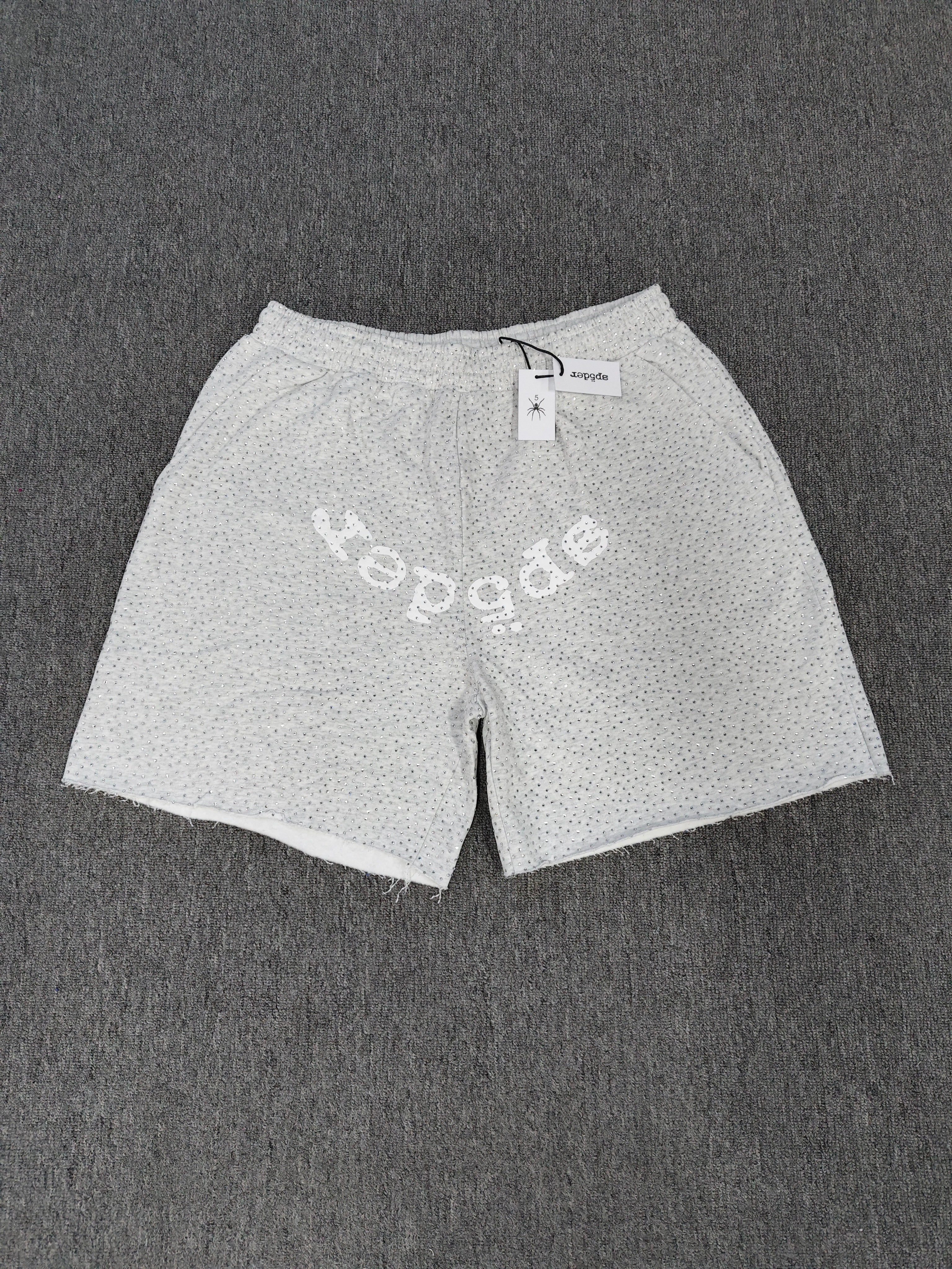 Sp5der VVS sweatshorts in heather grey feature a rhinestone logo and raw edge hemlines