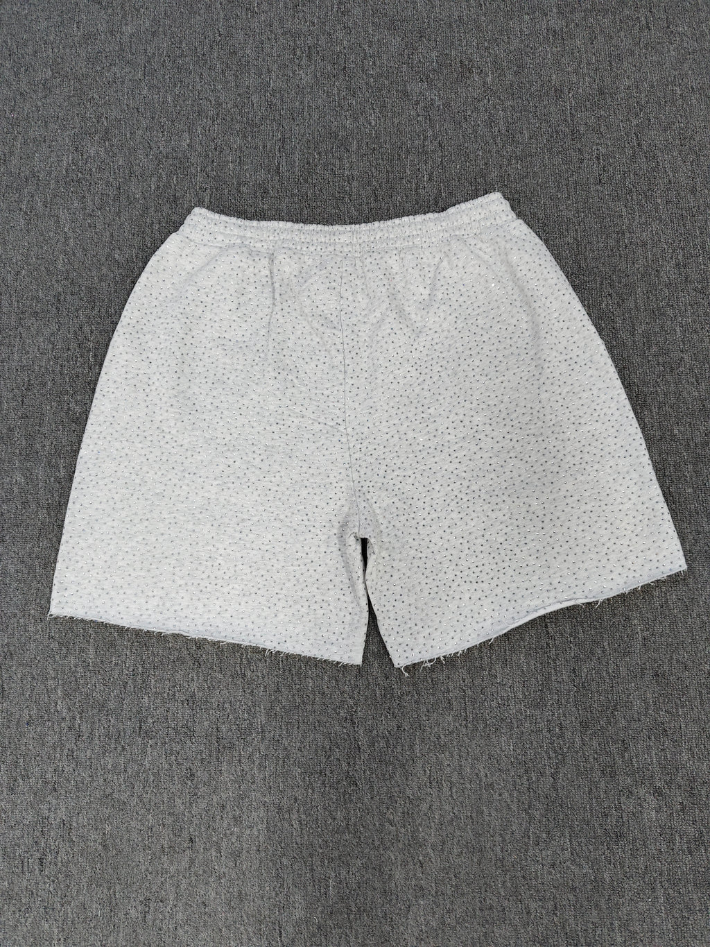 Sp5der VVS sweatshorts in heather grey feature a rhinestone logo and raw edge hemlines