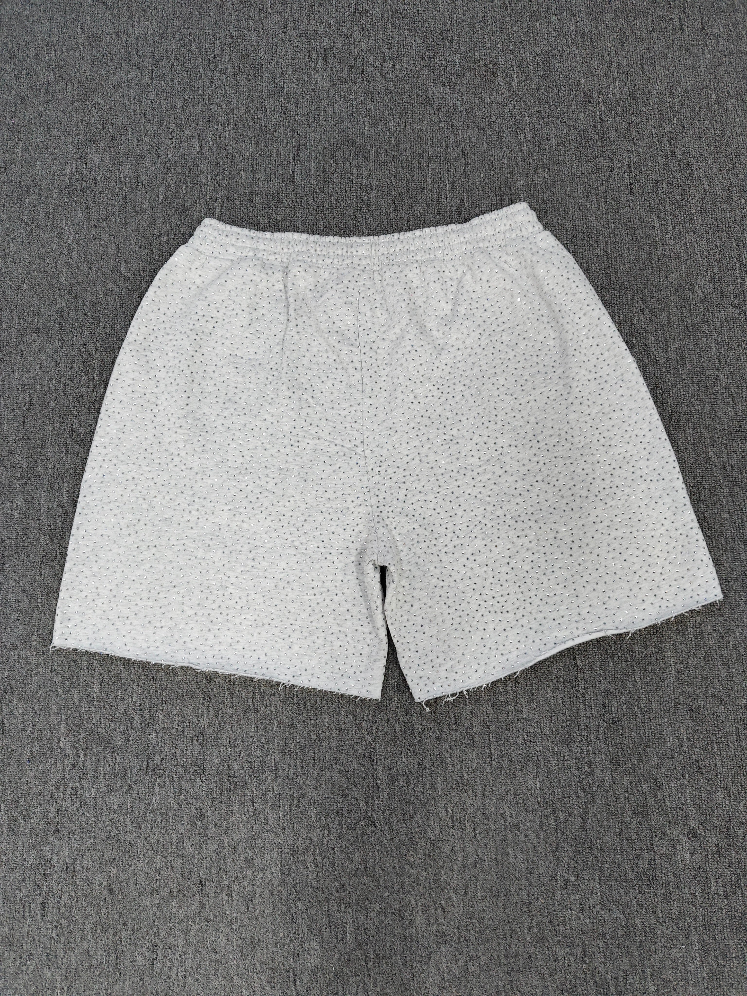 Sp5der VVS sweatshorts in heather grey feature a rhinestone logo and raw edge hemlines