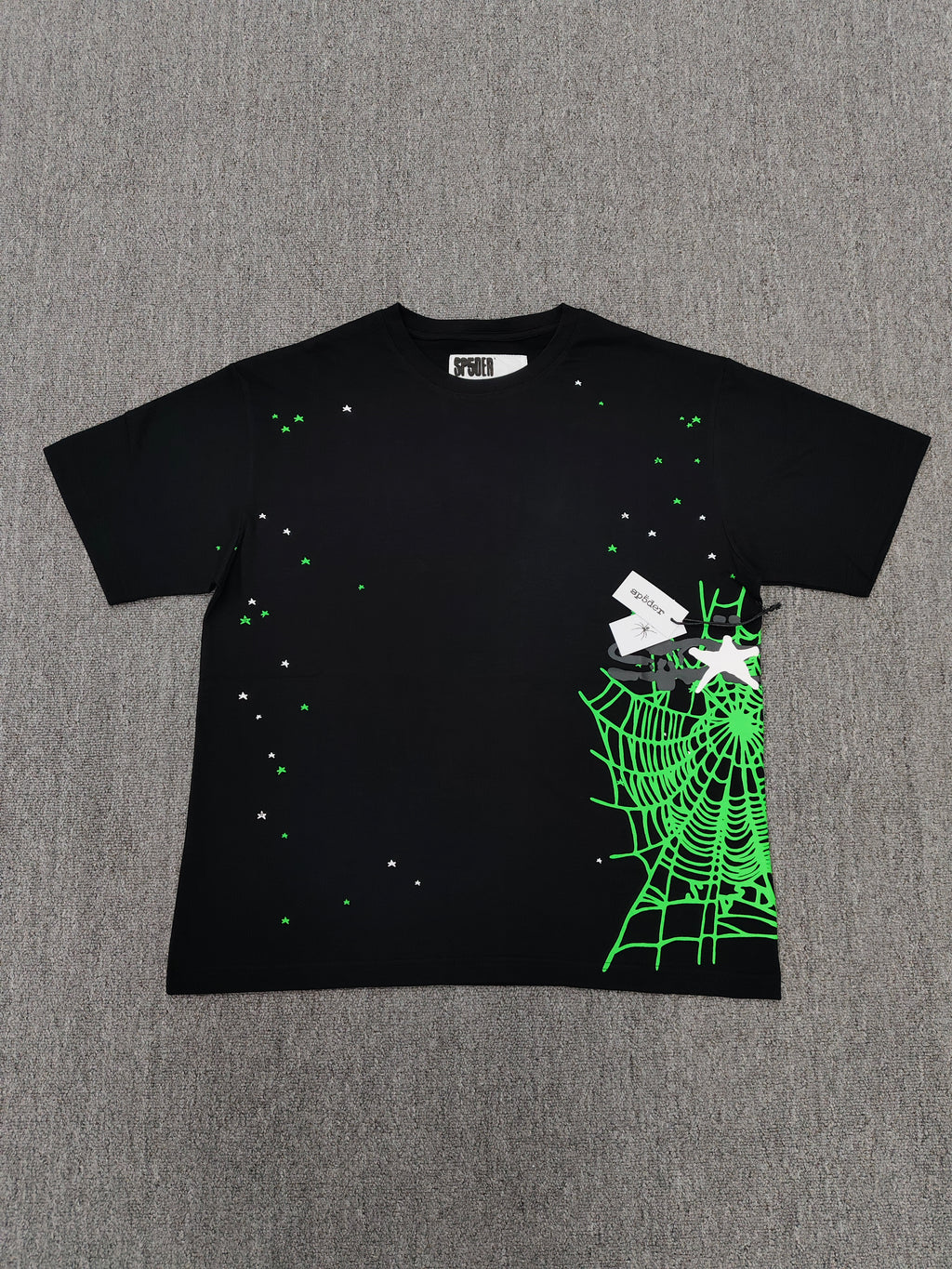 a Sp5der Heavy Web T-shirt in black featuring a prominent neon green web graphic and scattered star print
