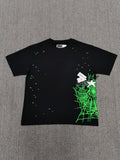 a Sp5der Heavy Web T-shirt in black featuring a prominent neon green web graphic and scattered star print