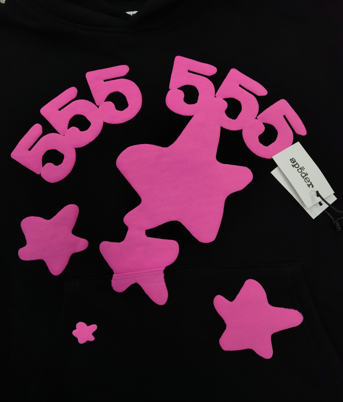 Sp5der Beluga Angel Number Hoodie in black featuring a prominent pink puff-print graphic on the chest