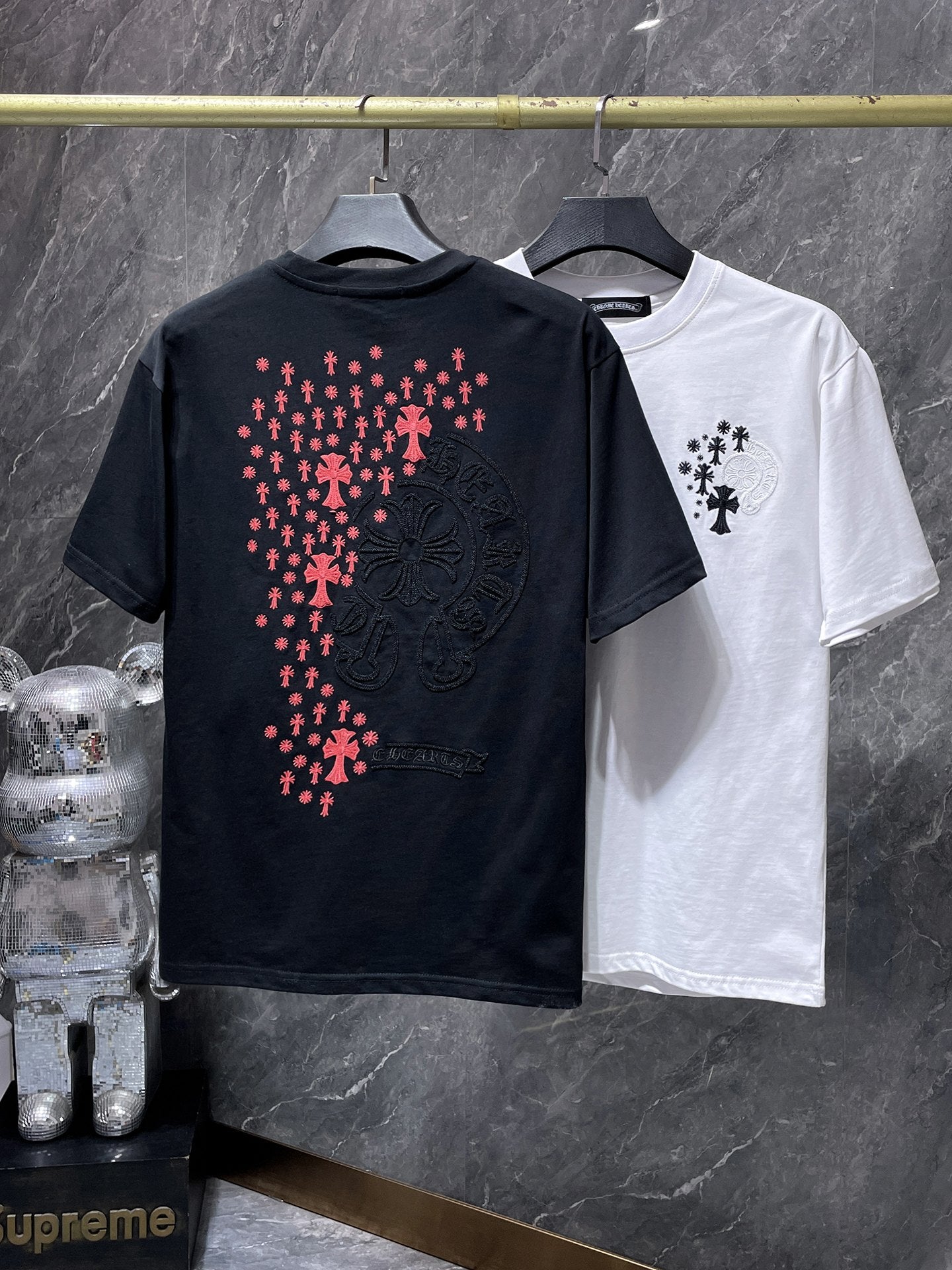 a Chrome Hearts branded short-sleeve t-shirt featuring distinctive embroidered gothic cross and horseshoe graphic details on the back