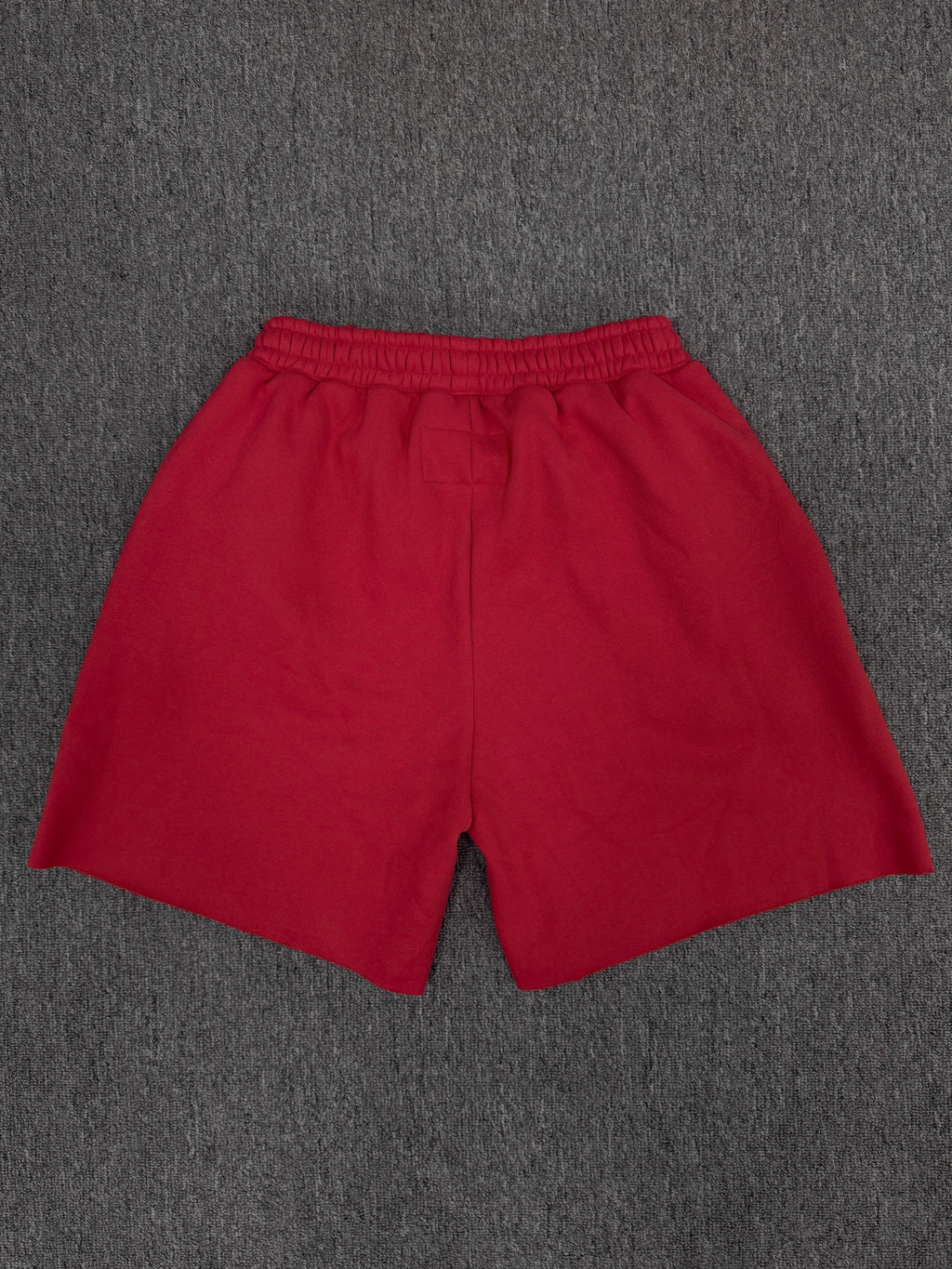 red Sp5der Angel Number Shorts featuring pink "555" graphics and star-shaped paint splatters