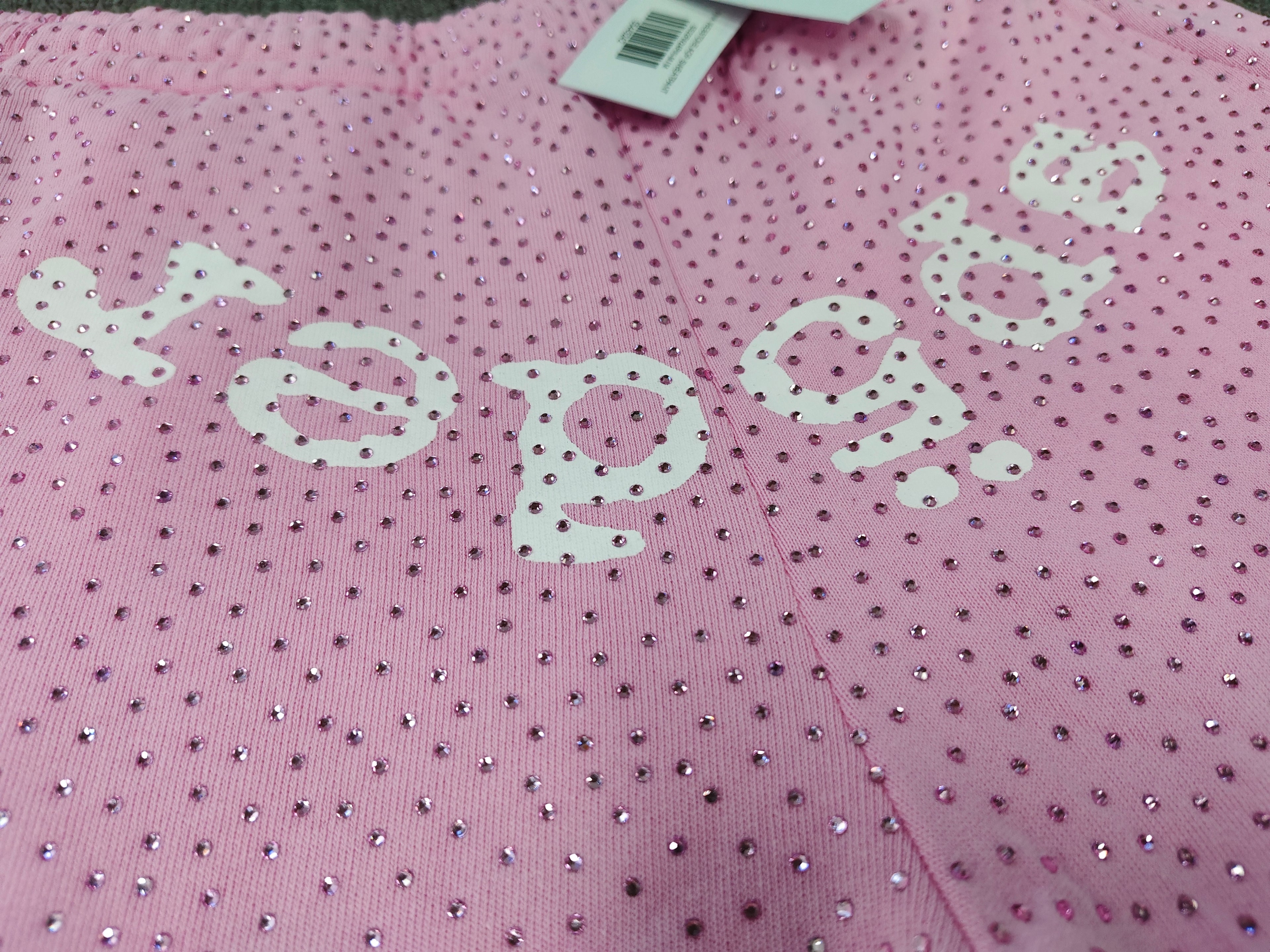 pink Sp5der sweatpants feature an all-over tonal rhinestone application and a SP5DER logo printed across the crotch