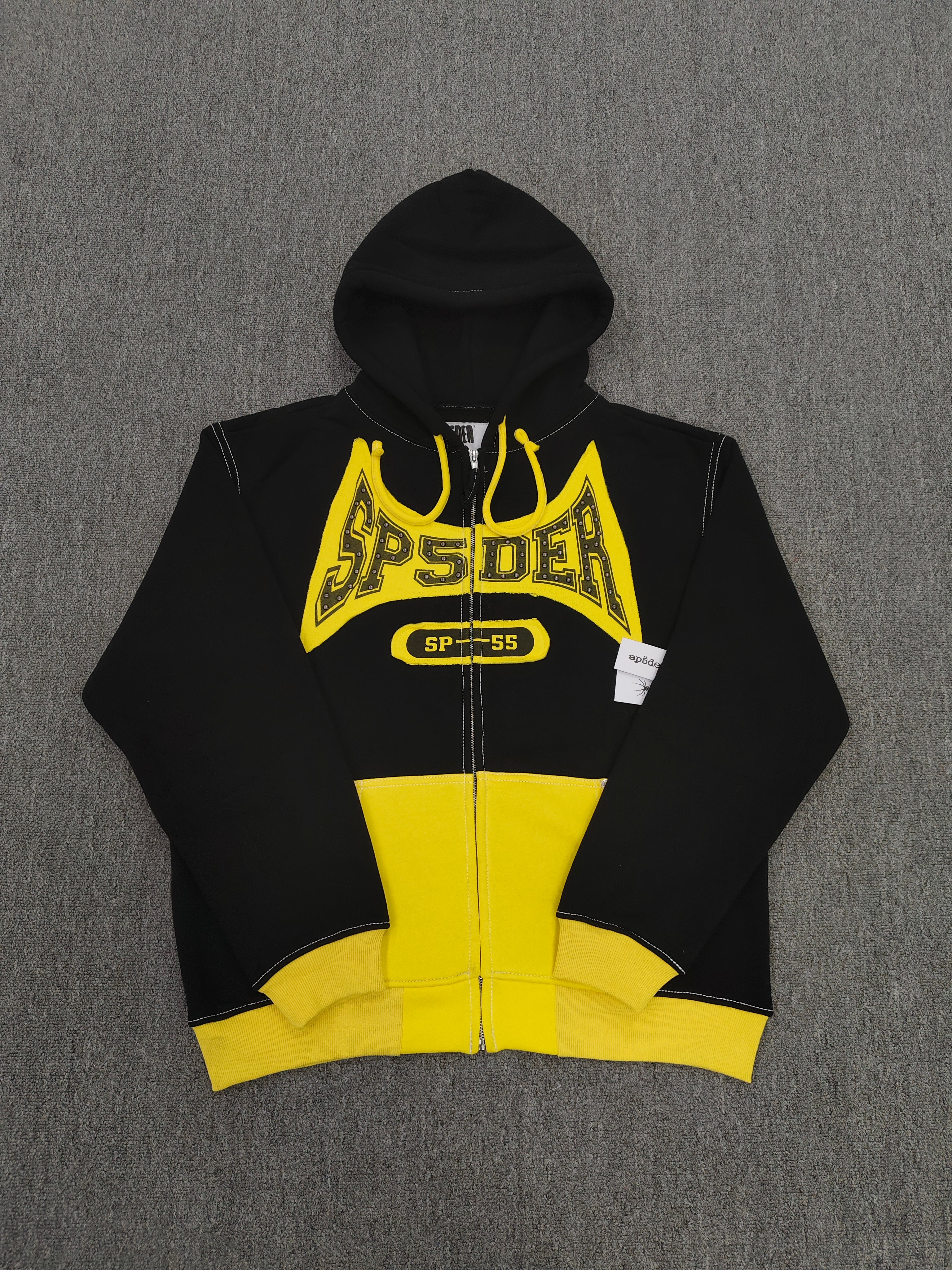 a Sp5der T&F Zip Hoodie in black and yellow with contrast stitching