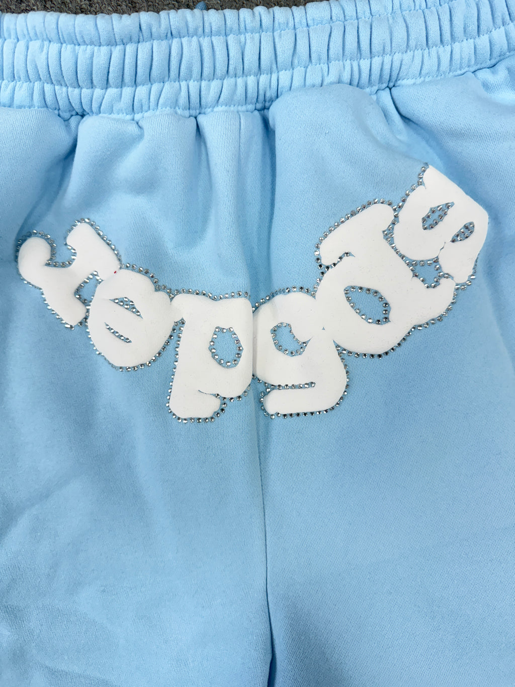 Sp5der OG Web Sweatshorts in Sky Blue, featuring the brand's signature webbed logo graphic on the front