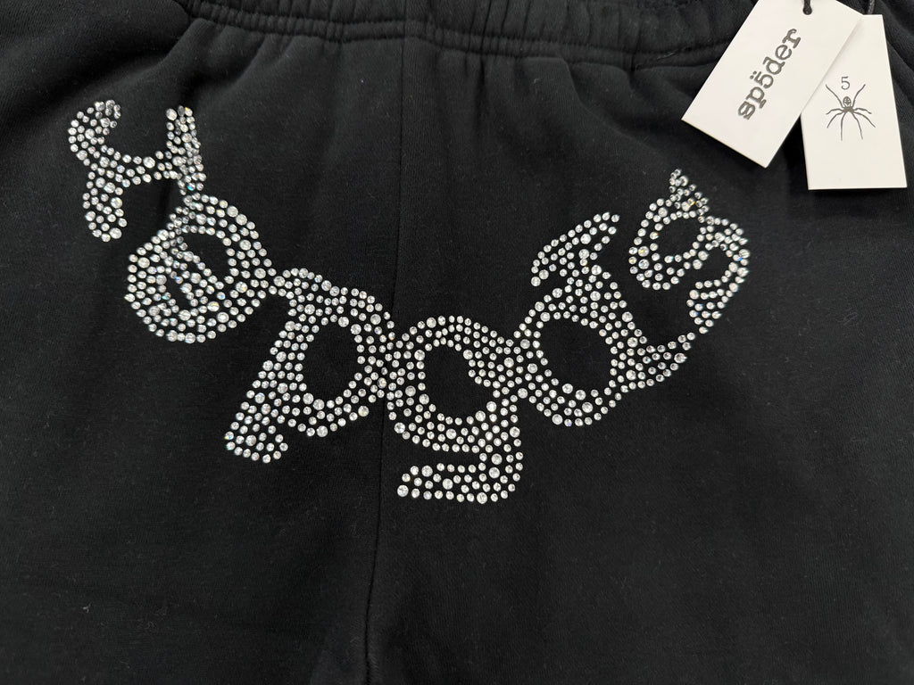 Sp5der OG Web Sweatpants in black, featuring distinctive rhinestone logo and star graphics