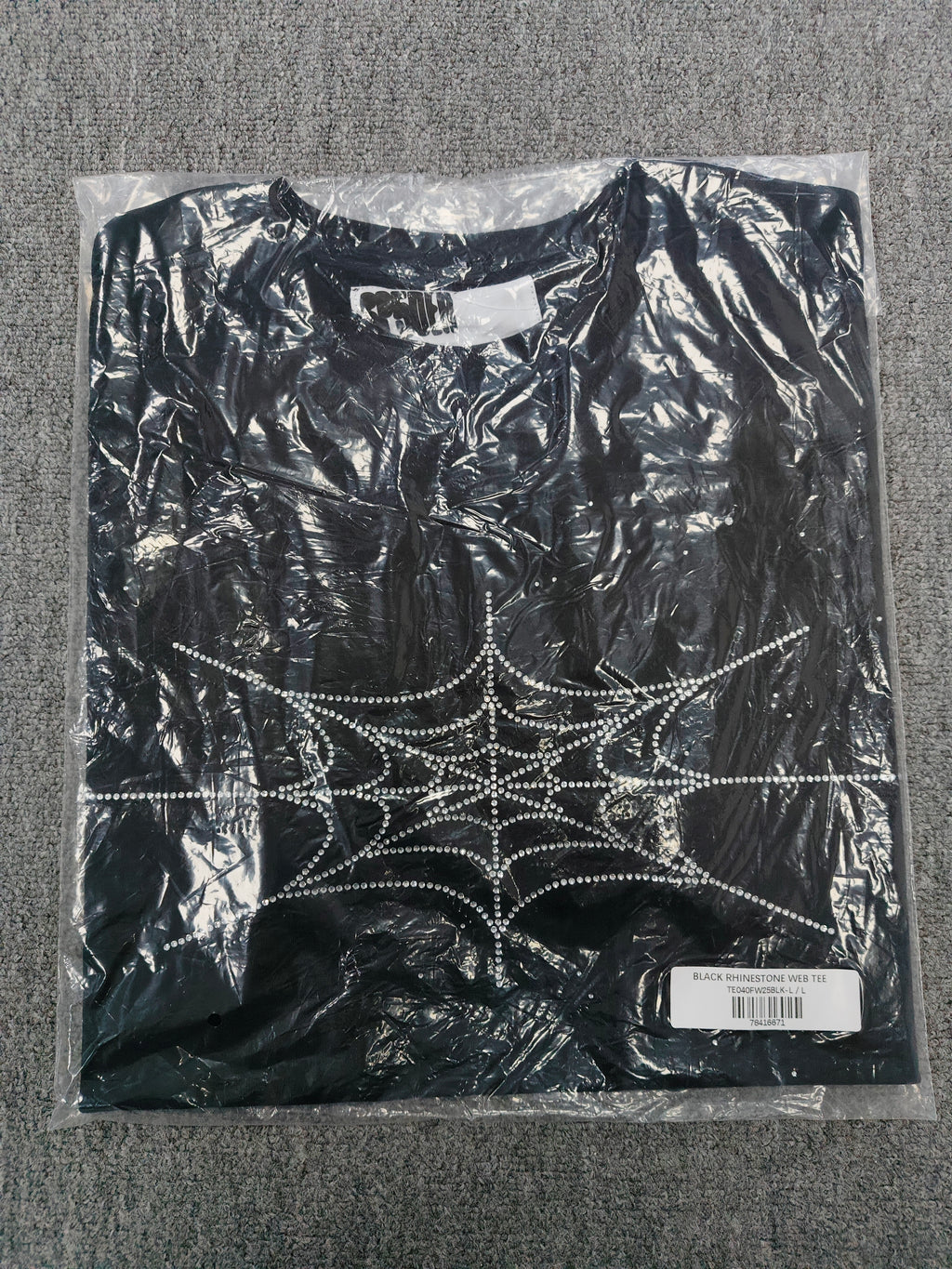 black Sp5der Rhinestone Silk Tee features a prominent crystal-embellished spider web graphic on the chest