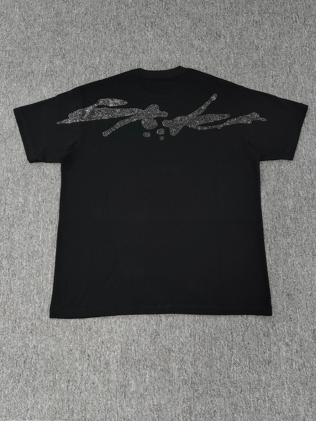 black Sp5der TM rhinestone tee features a central spider motif constructed from sparkling rhinestones
