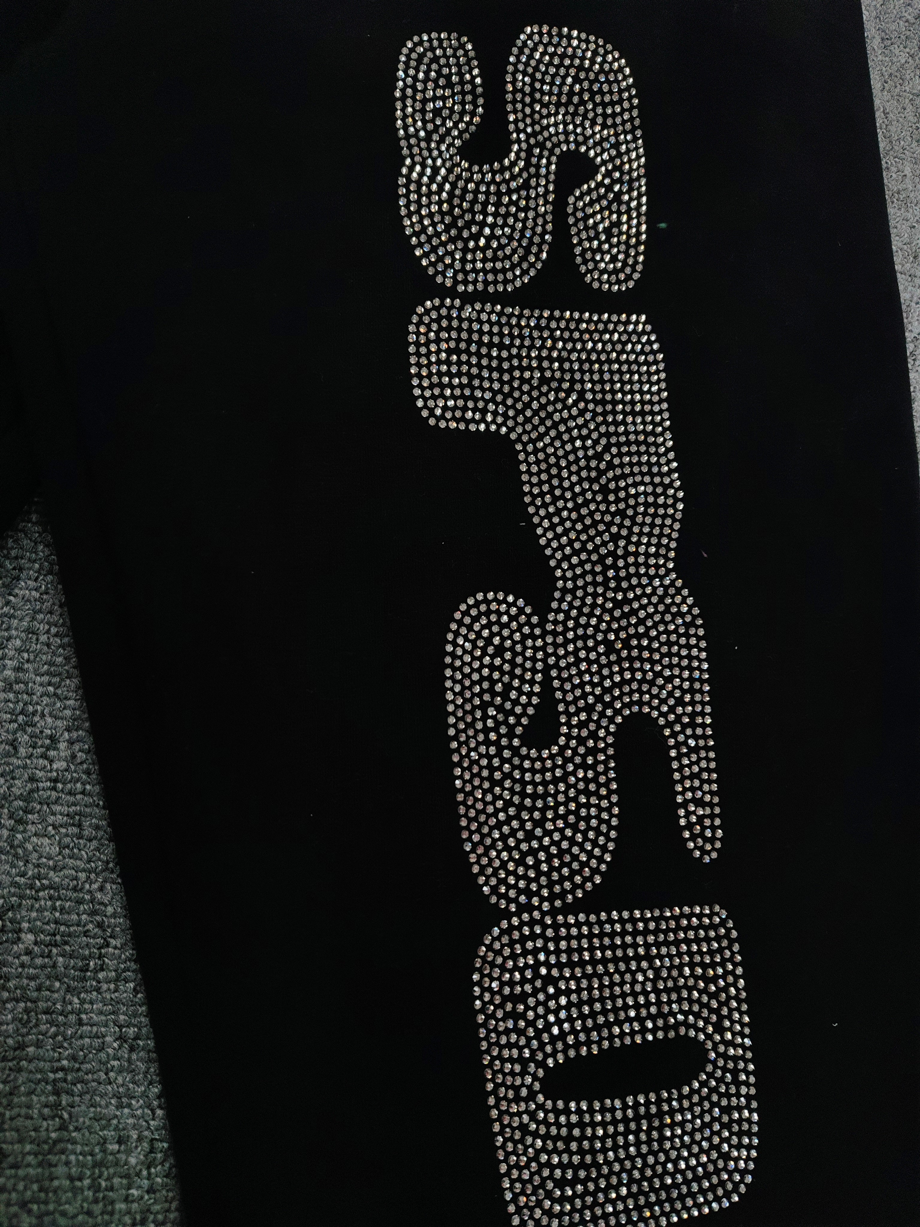 Sp5der Rhinestone Silk sweatpants in black featuring a large rhinestone-embellished logo and scattered star details