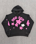 Sp5der Beluga Angel Number Hoodie in black featuring a prominent pink puff-print graphic on the chest