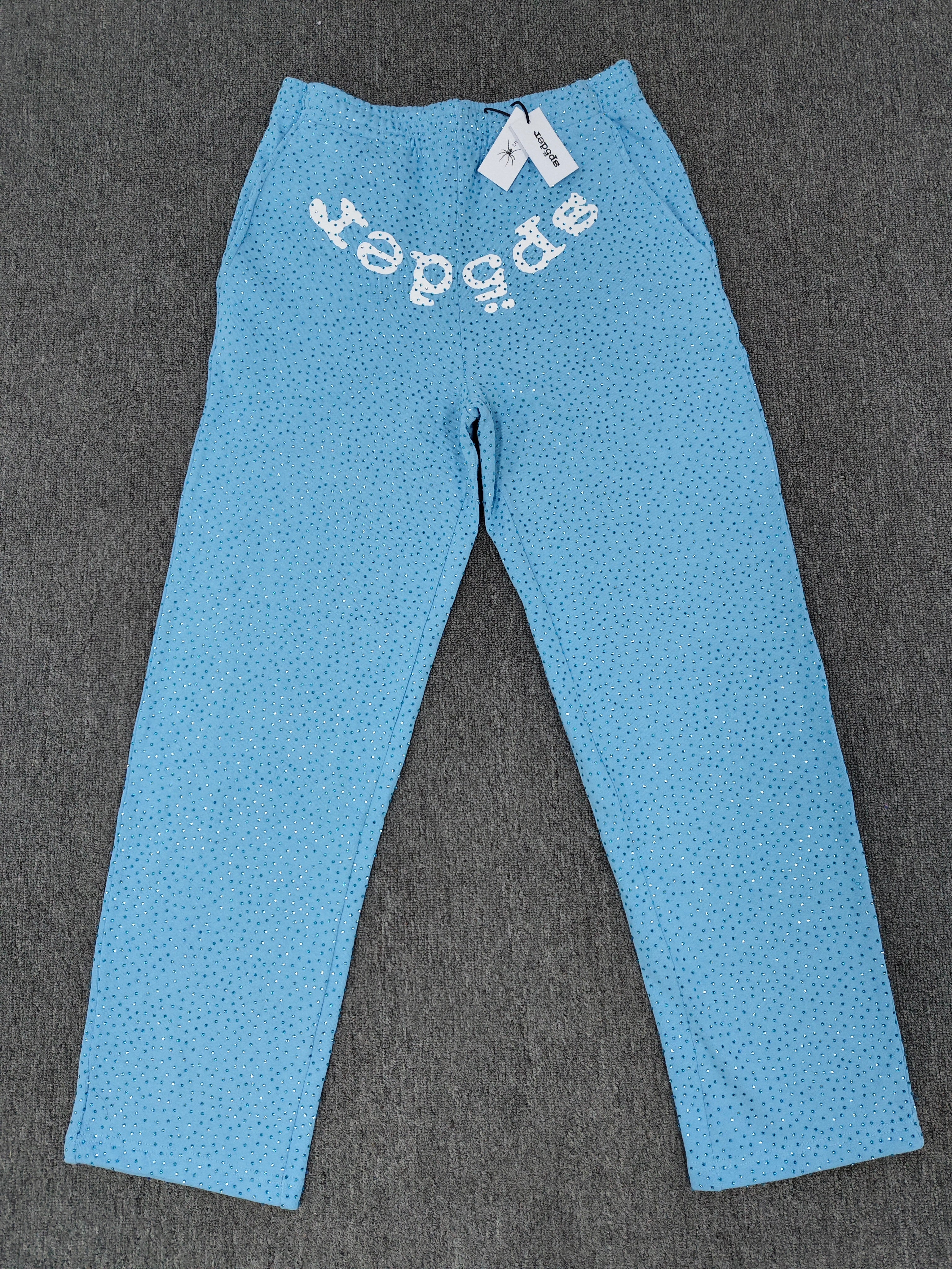sky blue Sp5der Classic Sweatpants feature an all-over rhinestone design and the brand's logo in a sparkling applique