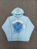 Sp5der OG Web Zip Up hoodie in Sky Blue features a prominent 3D puff-printed spider web graphic and rhinestone embellishments