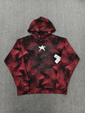 a Sp5der Plaid Splatt Hoodie in red, featuring a prominent white star graphic