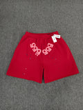 red Sp5der Angel Number Shorts featuring pink "555" graphics and star-shaped paint splatters