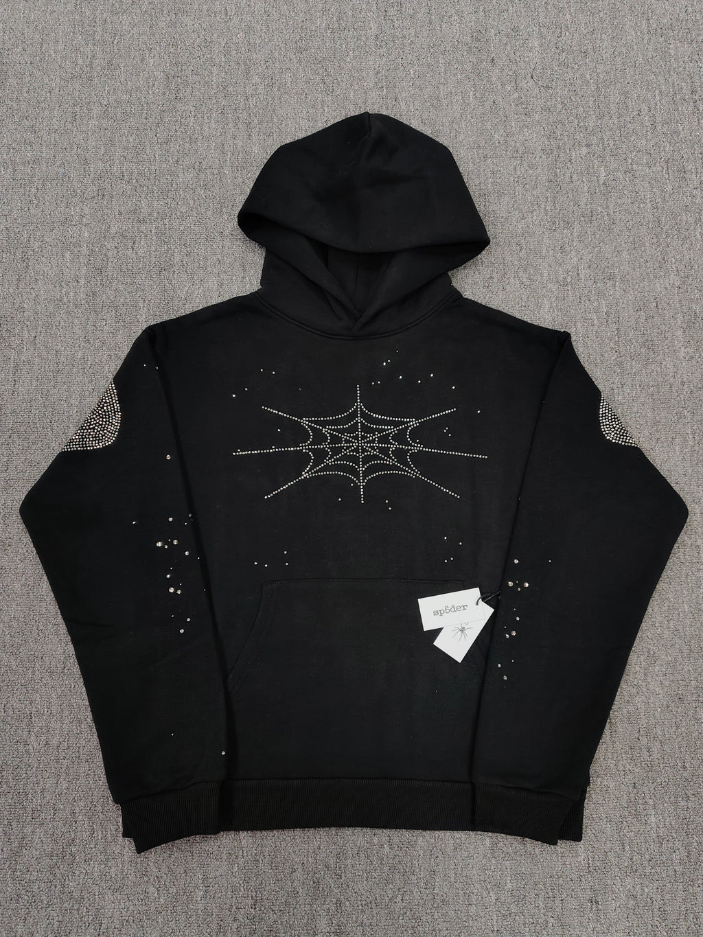 a Sp5der Rhinestone Silk Hoodie in black, featuring a prominent rhinestone web graphic on the front
