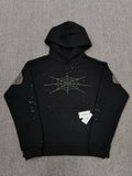 a Sp5der Rhinestone Silk Hoodie in black, featuring a prominent rhinestone web graphic on the front
