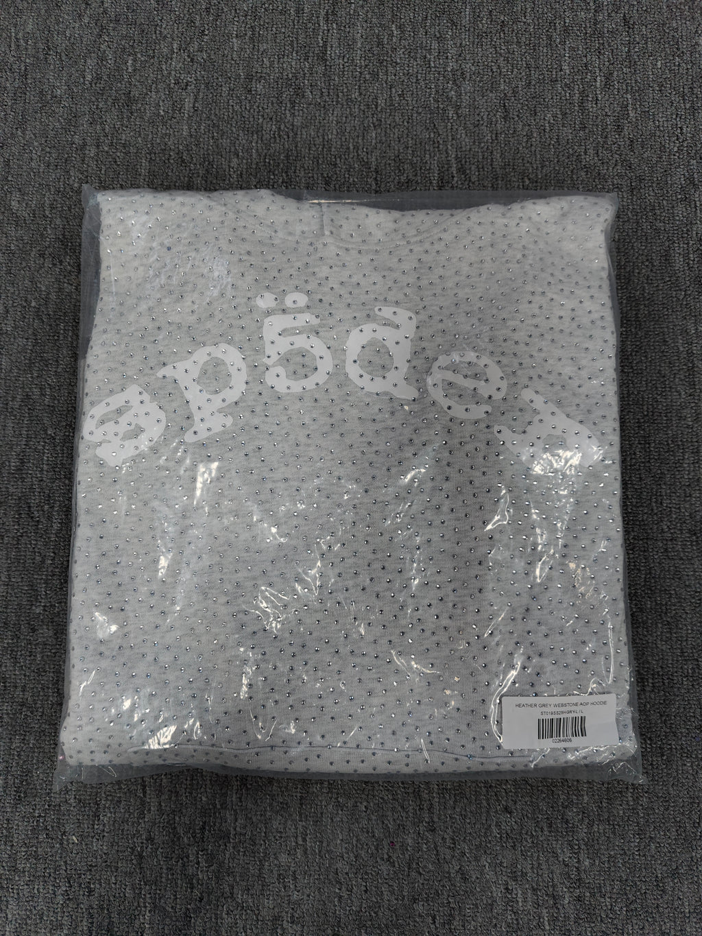 a Sp5der VVS Hoodie in Heather Grey, recognized by its all-over tonal rhinestones and arch logo