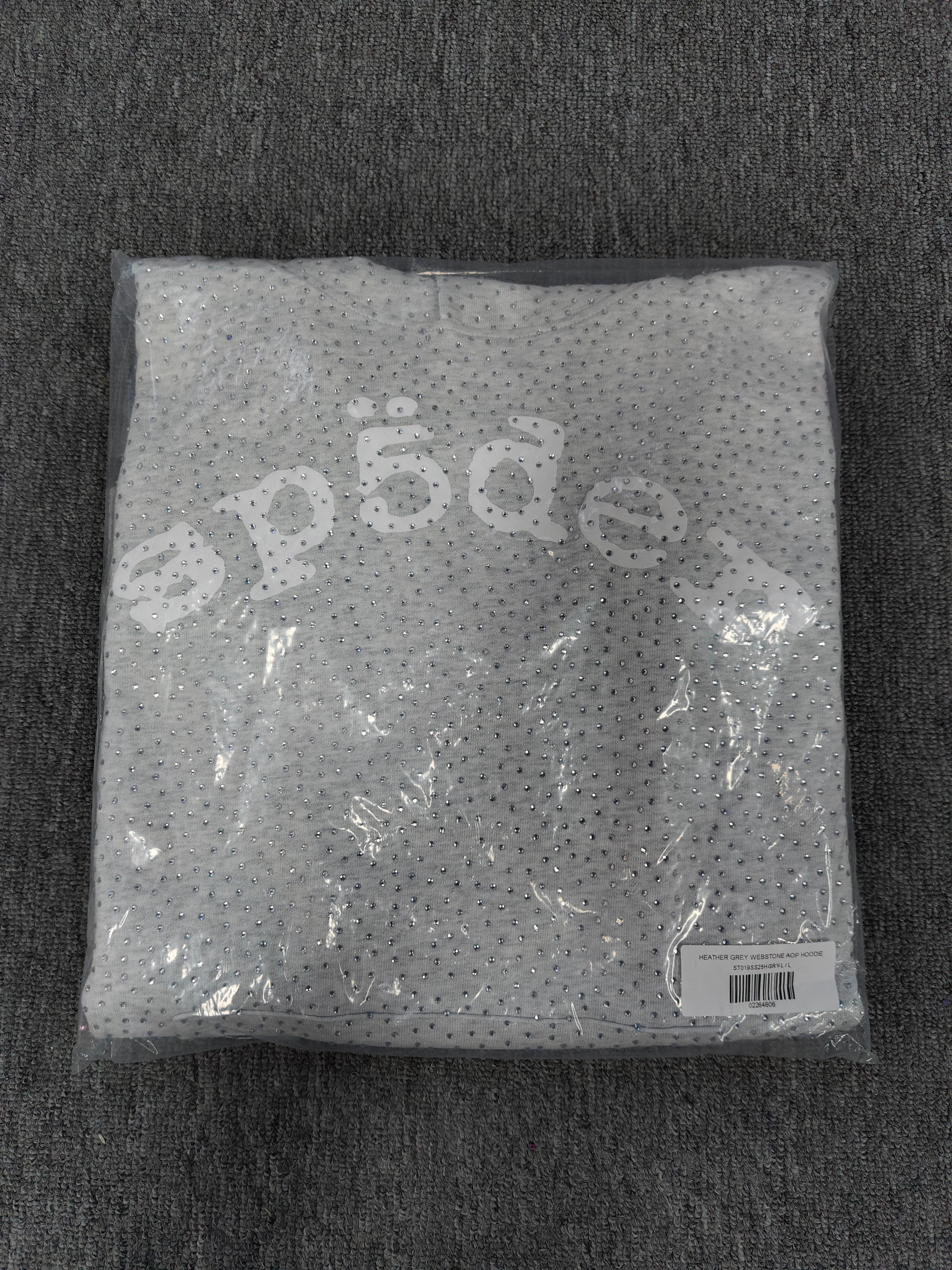 a Sp5der VVS Hoodie in Heather Grey, recognized by its all-over tonal rhinestones and arch logo