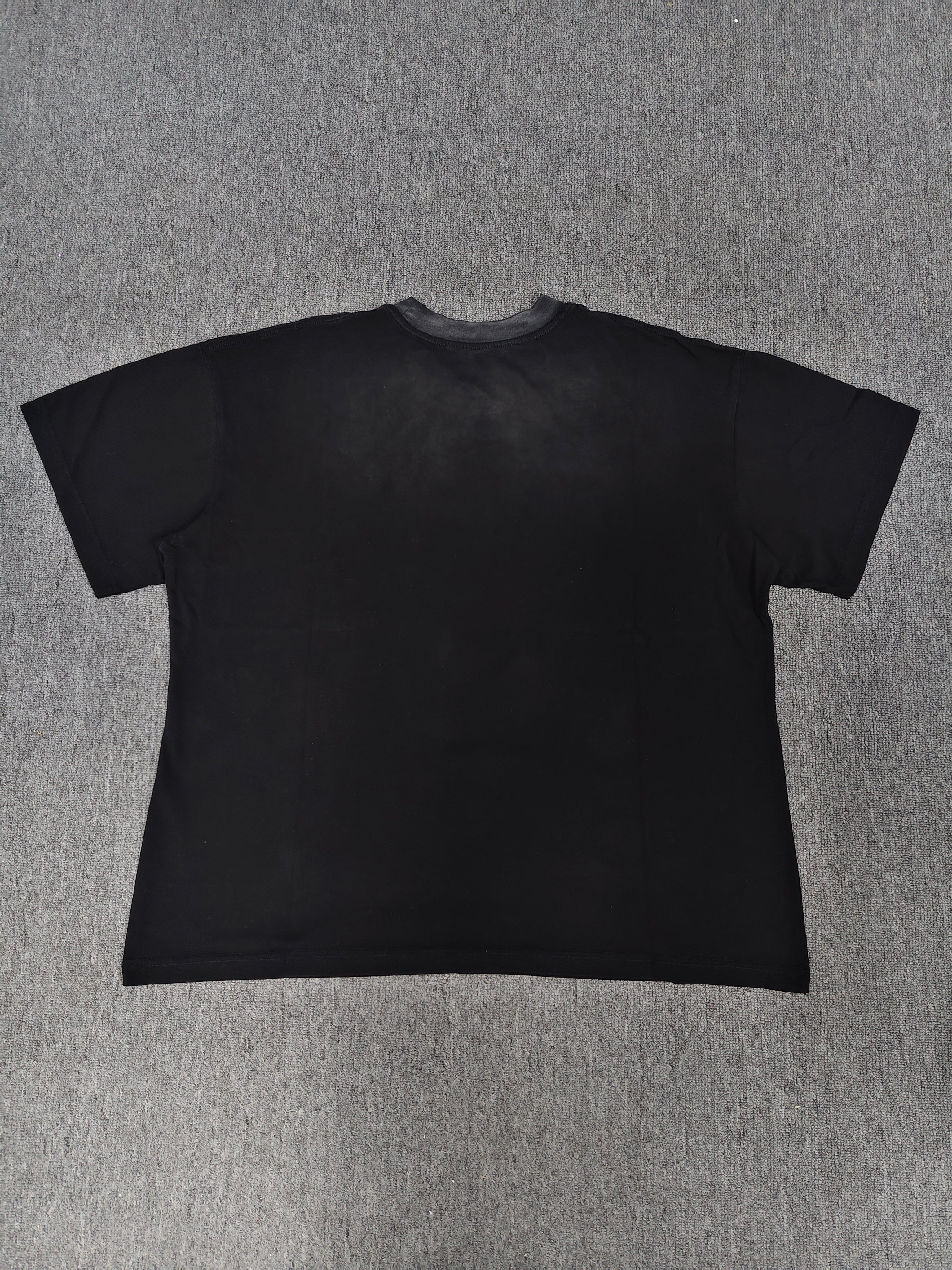 a black Travis Scott x Sp5der "Days Before Rodeo" collaboration t-shirt featuring a distinctive red "Rodeo" graphic and faded branding