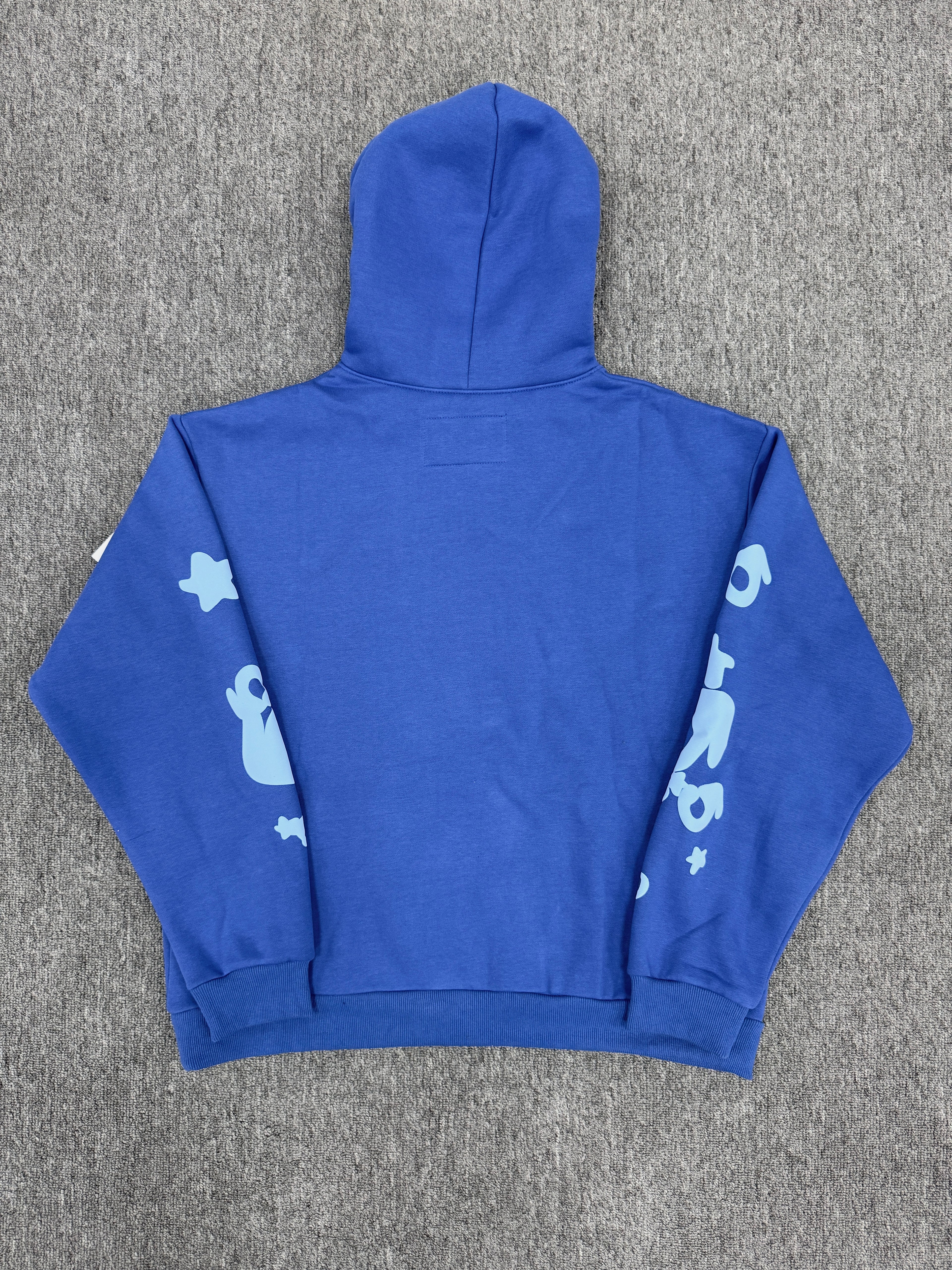 blue Sp5der Beluga hoodie features a distinct light blue graphic print of stars and the brand name on the front and sleeves
