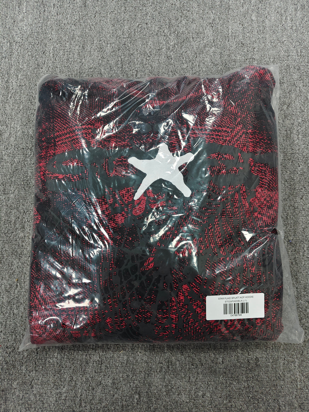 a Sp5der Plaid Splatt Hoodie in red, featuring a prominent white star graphic