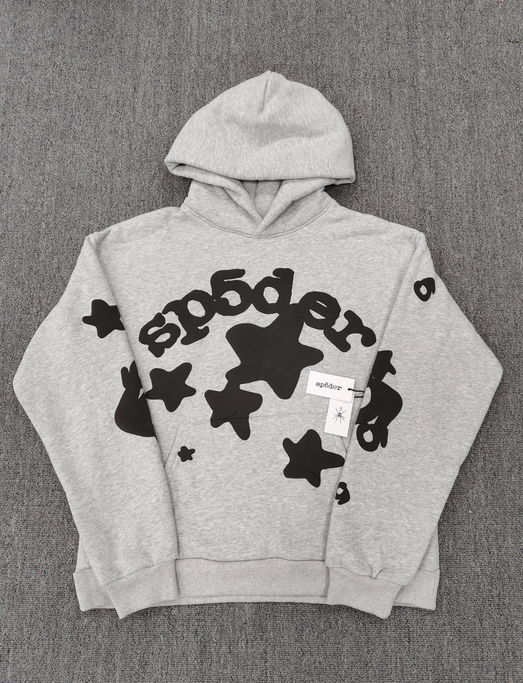 Sp5der Worldwide Beluga hoodie features a distinctive black star graphic across the chest on a light grey heather fabric