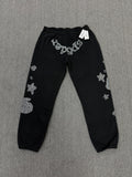 Sp5der OG Web Sweatpants in black, featuring distinctive rhinestone logo and star graphics