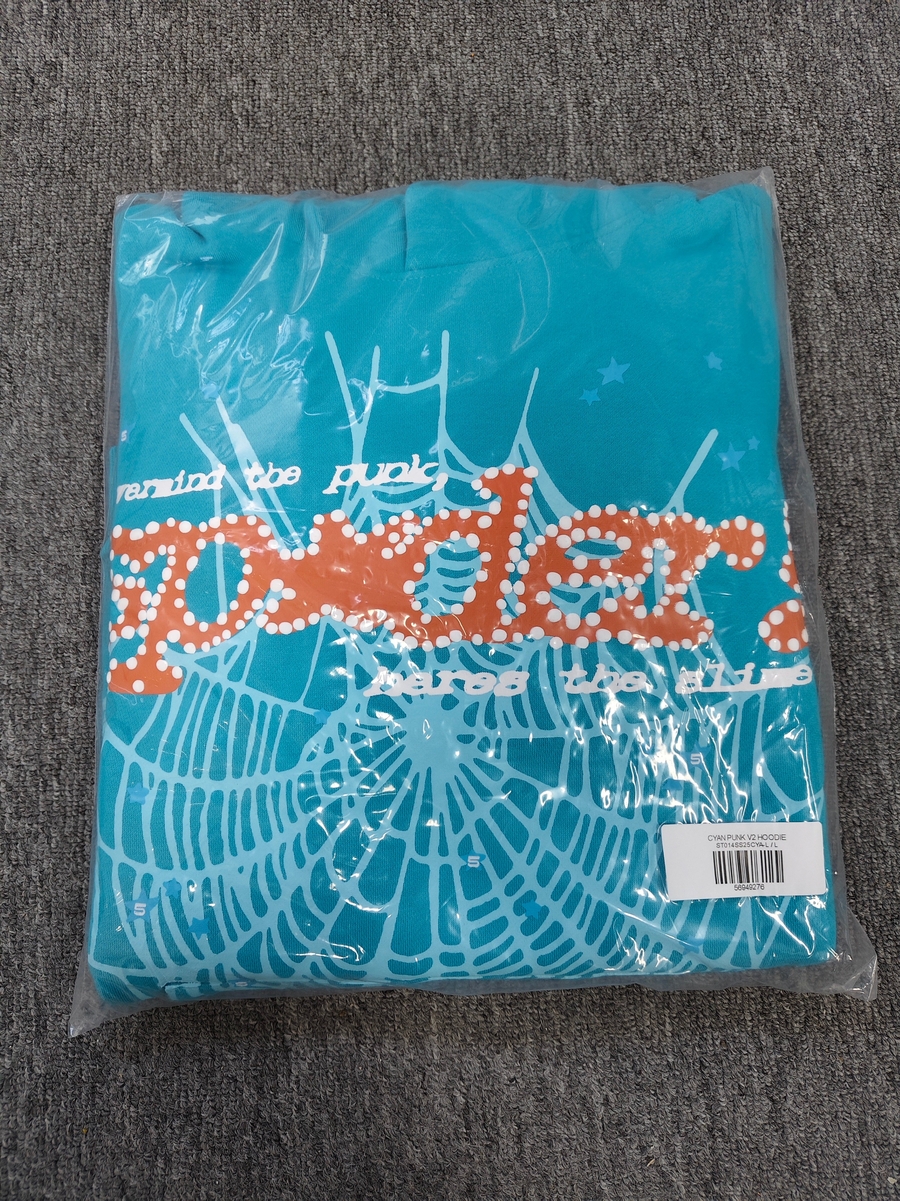 a Sp5der Punk V2 Hoodie in the Cyan colorway, featuring a prominent rhinestone graphic and spider web motif