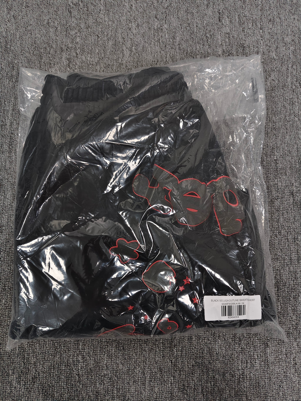 Sp5der Beluga Outline Sweatshorts in black, featuring prominent red-outlined graphic logos and stars