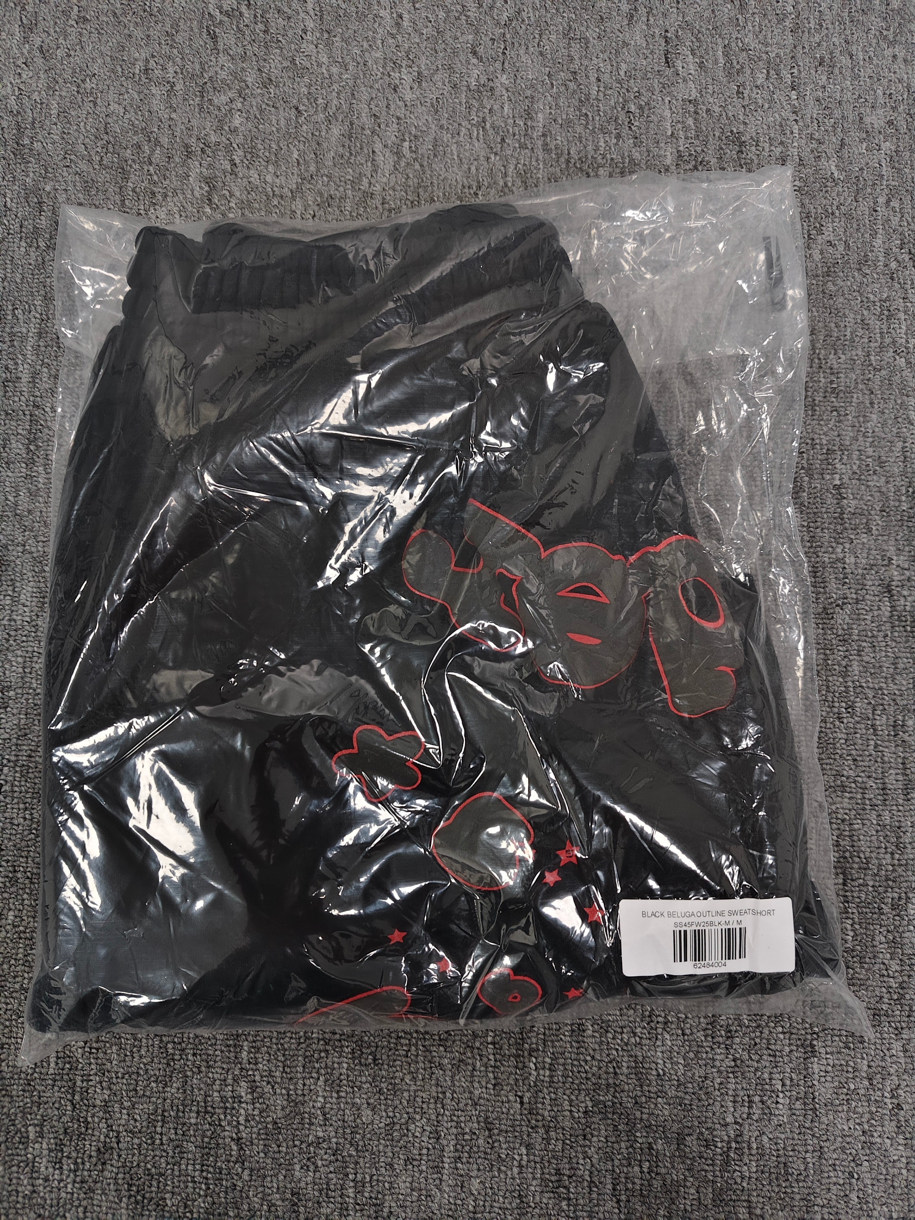 Sp5der Beluga Outline Sweatshorts in black, featuring prominent red-outlined graphic logos and stars