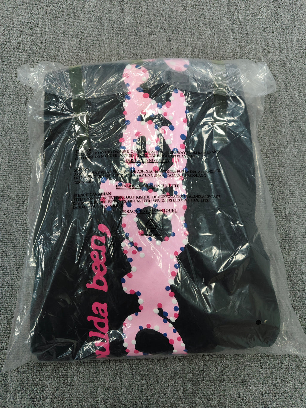black Sp5der x Coulda Been sweatpants featuring a prominent pink "spider!" graphic and multi-colored star embroidery