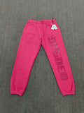 pink Sp5der sweatpants feature rhinestone branding down the leg and are identified as the Rhinestone Silk Sweatpant model