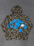 Sp5der Beluga hoodie features a distinct tiger camo pattern and vibrant blue star graphics