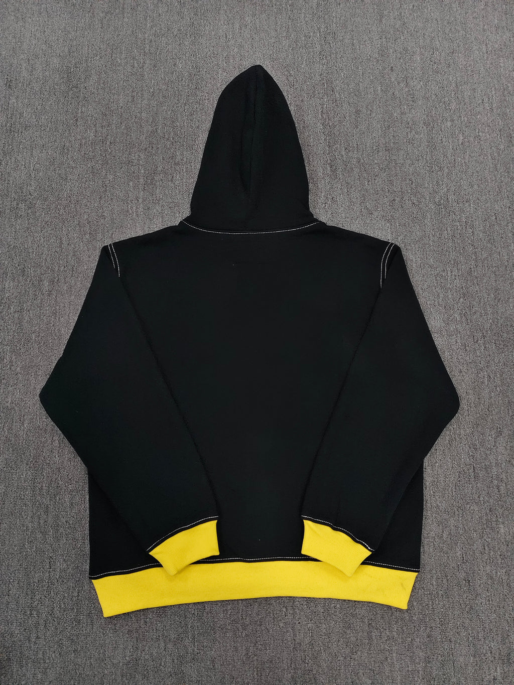 a Sp5der T&F Zip Hoodie in black and yellow with contrast stitching