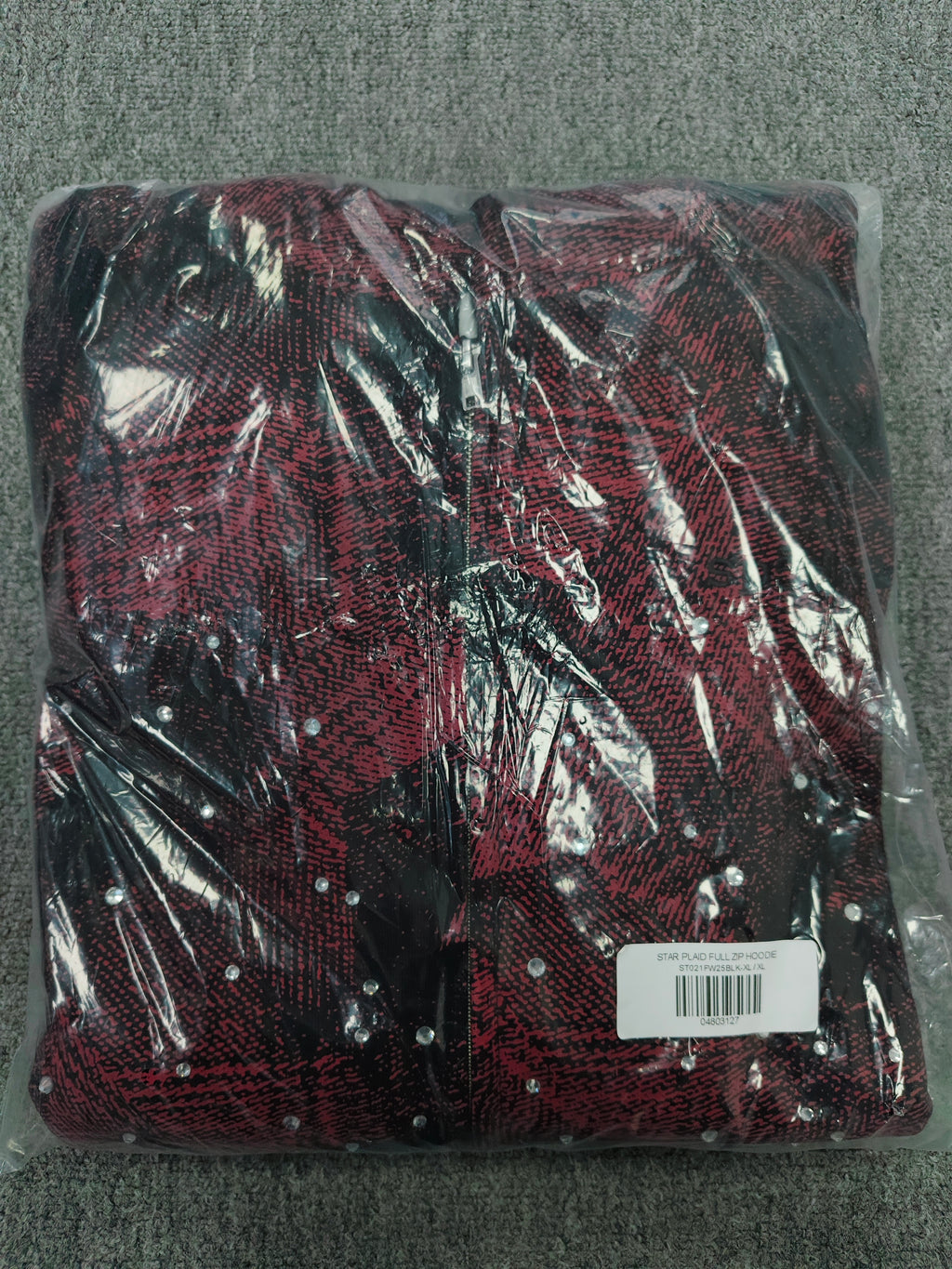 a Sp5der Star Plaid Full Zip Hoodie in a red and black plaid pattern