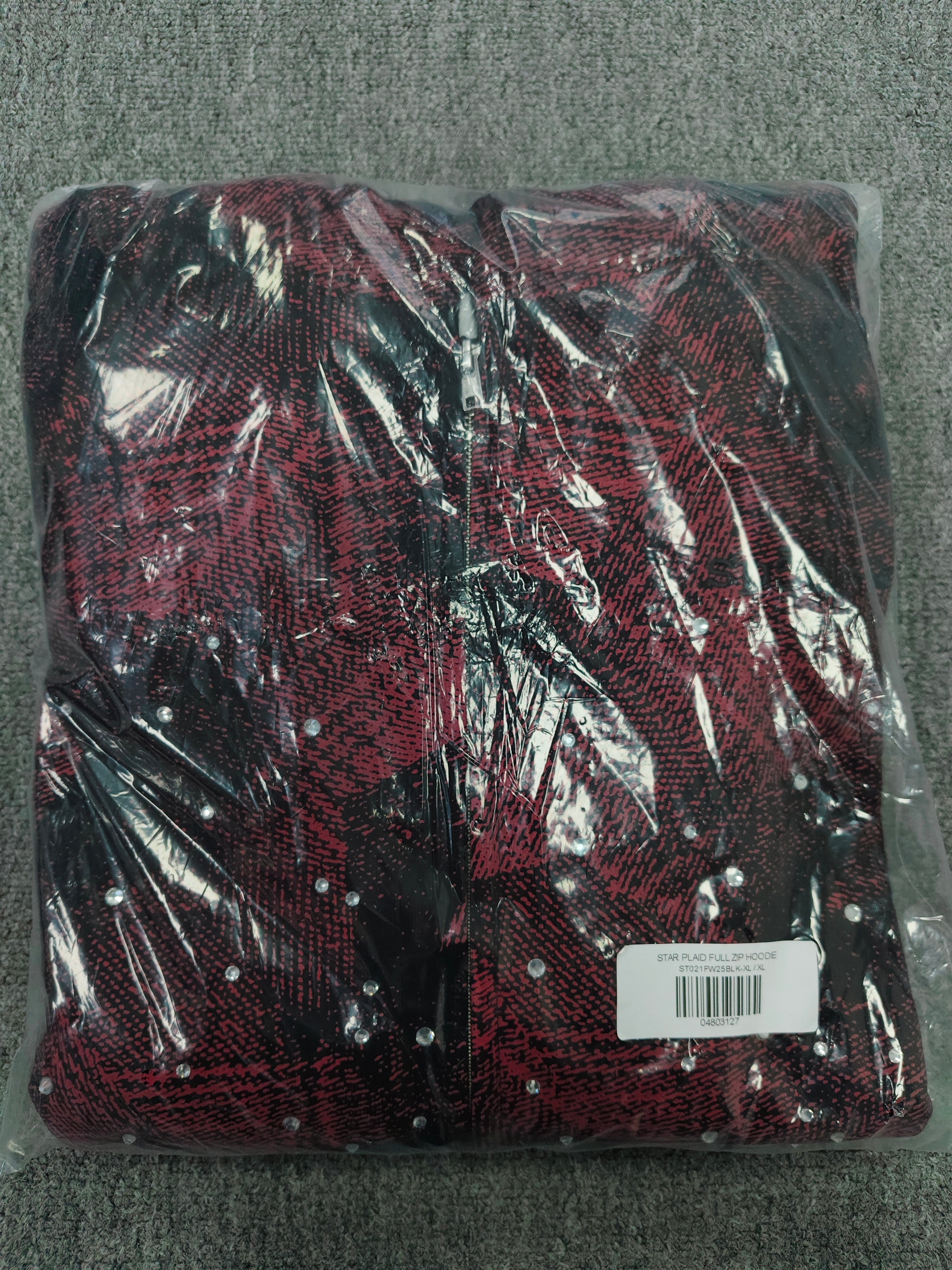 a Sp5der Star Plaid Full Zip Hoodie in a red and black plaid pattern