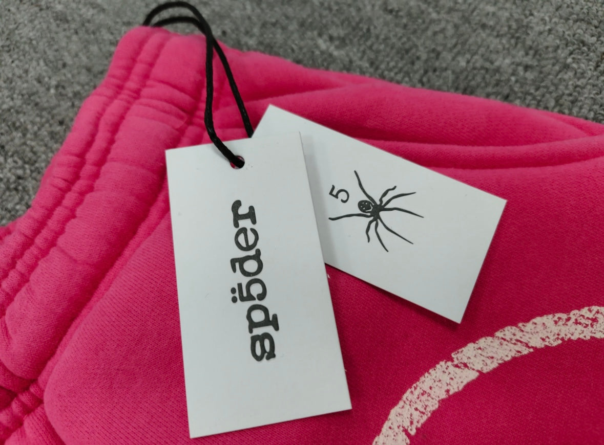 SP5DER Stencil Sweatpants in pink, featuring a large black star graphic on the left leg