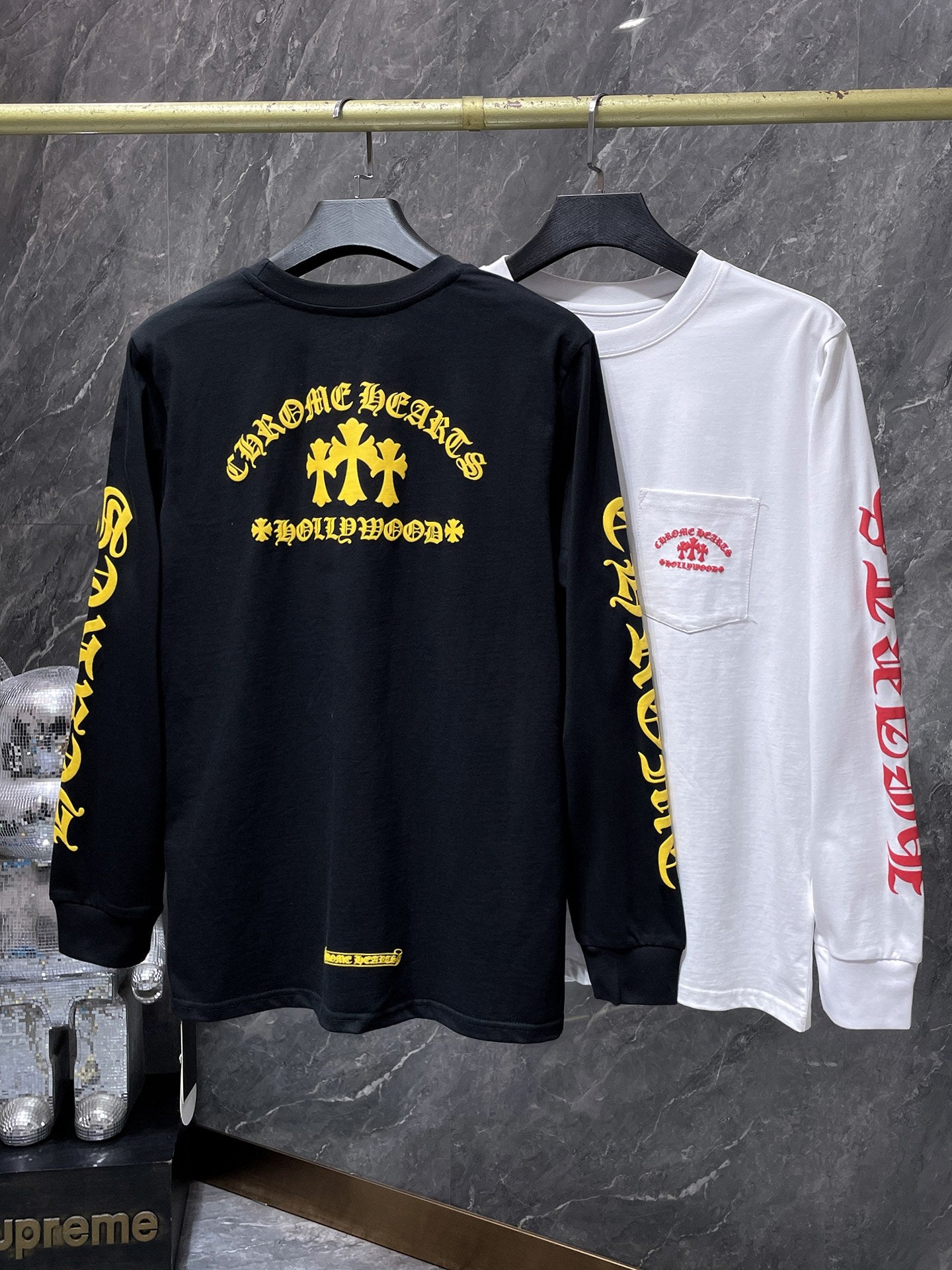 a Chrome Hearts Hollywood Triple Cross Long Sleeve T-Shirt featuring a prominent graphic on the back.