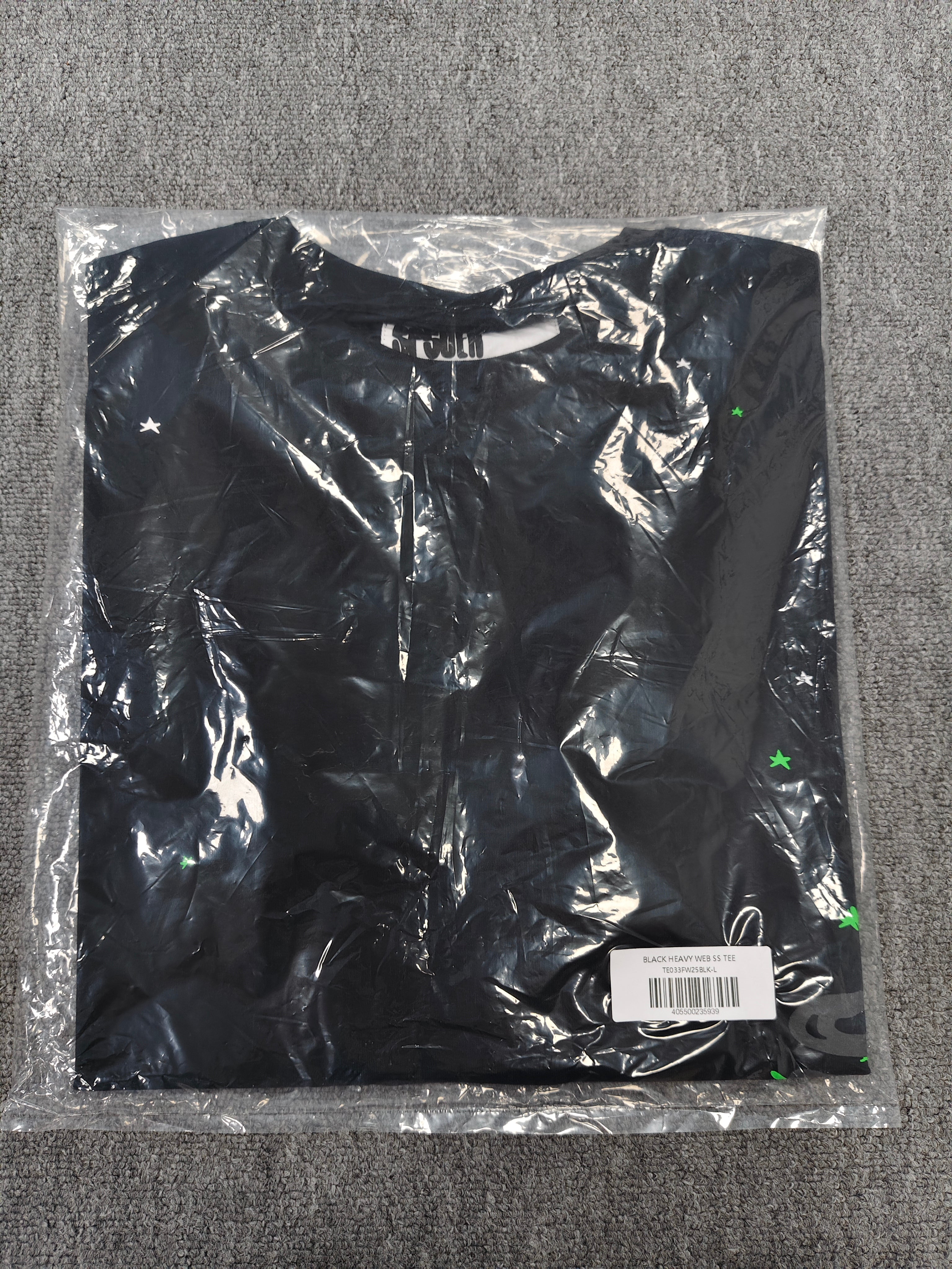 a Sp5der Heavy Web T-shirt in black featuring a prominent neon green web graphic and scattered star print