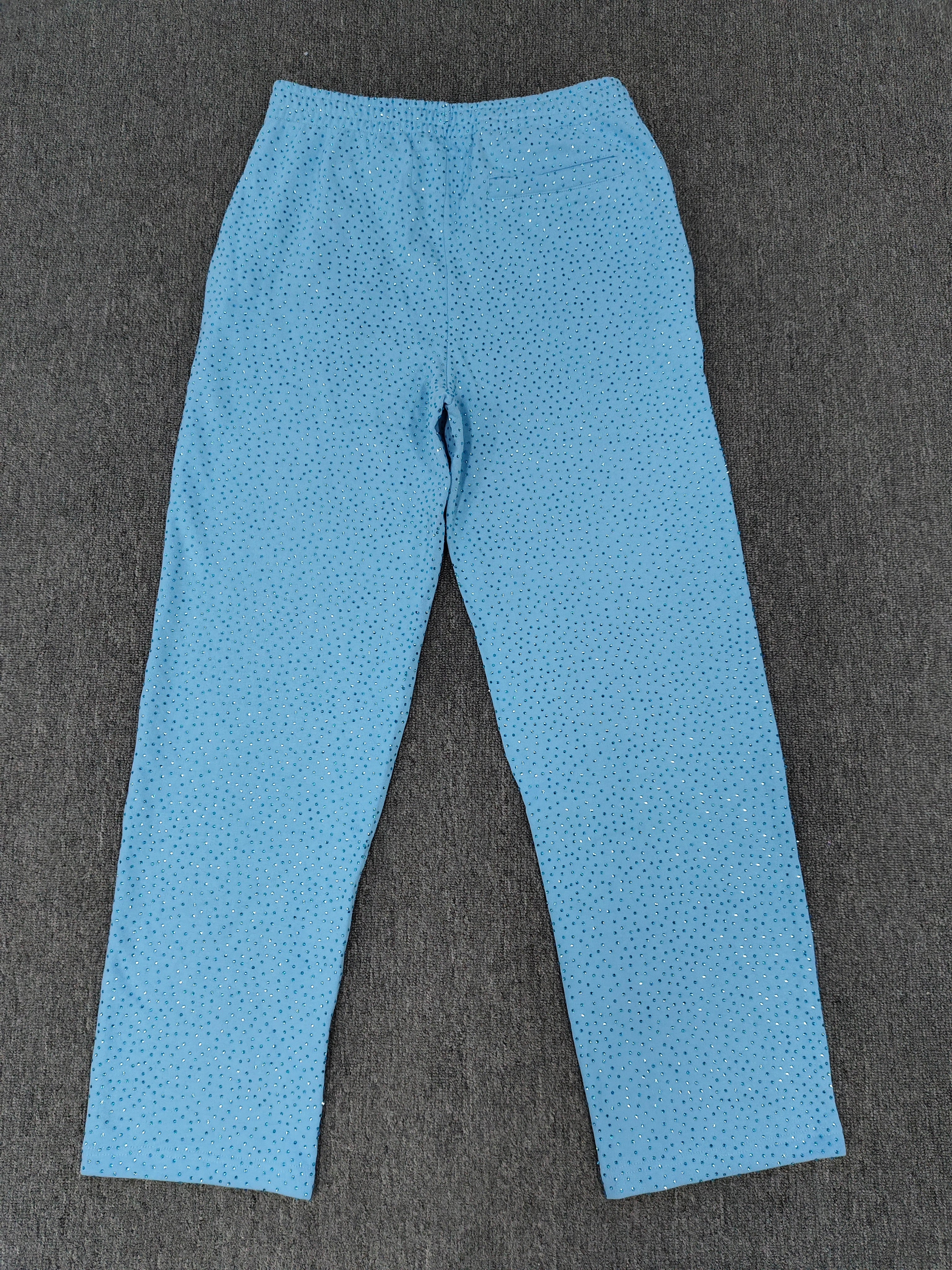 sky blue Sp5der Classic Sweatpants feature an all-over rhinestone design and the brand's logo in a sparkling applique
