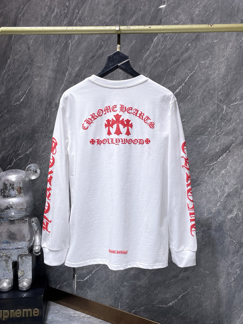 a Chrome Hearts Hollywood Triple Cross Long Sleeve T-Shirt featuring a prominent graphic on the back.