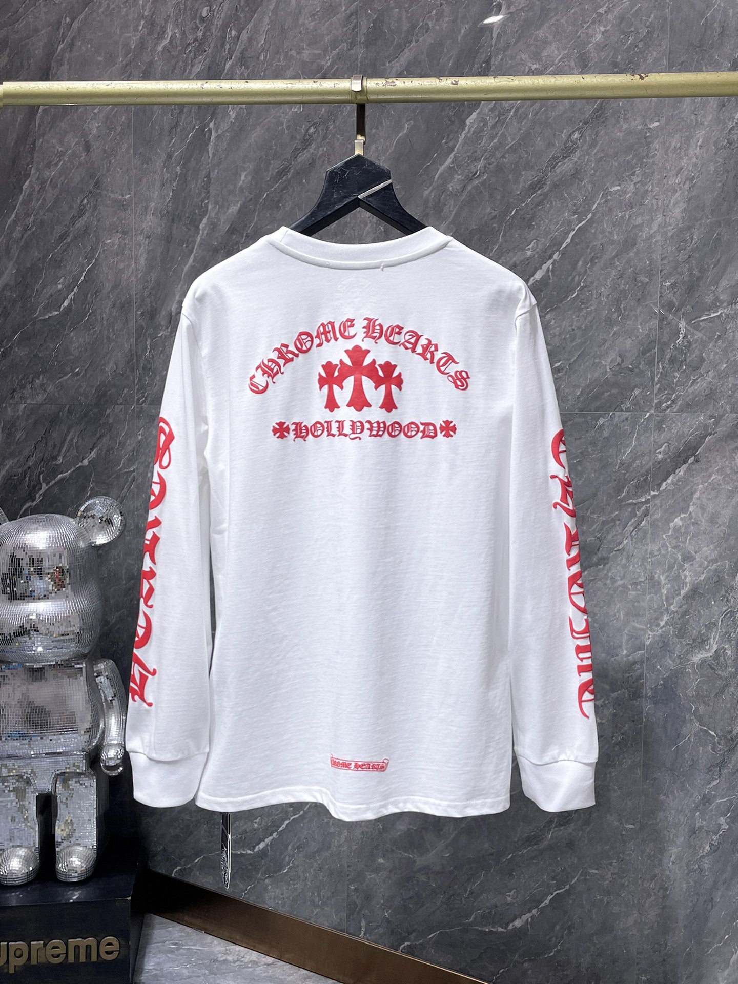 a Chrome Hearts Hollywood Triple Cross Long Sleeve T-Shirt featuring a prominent graphic on the back.