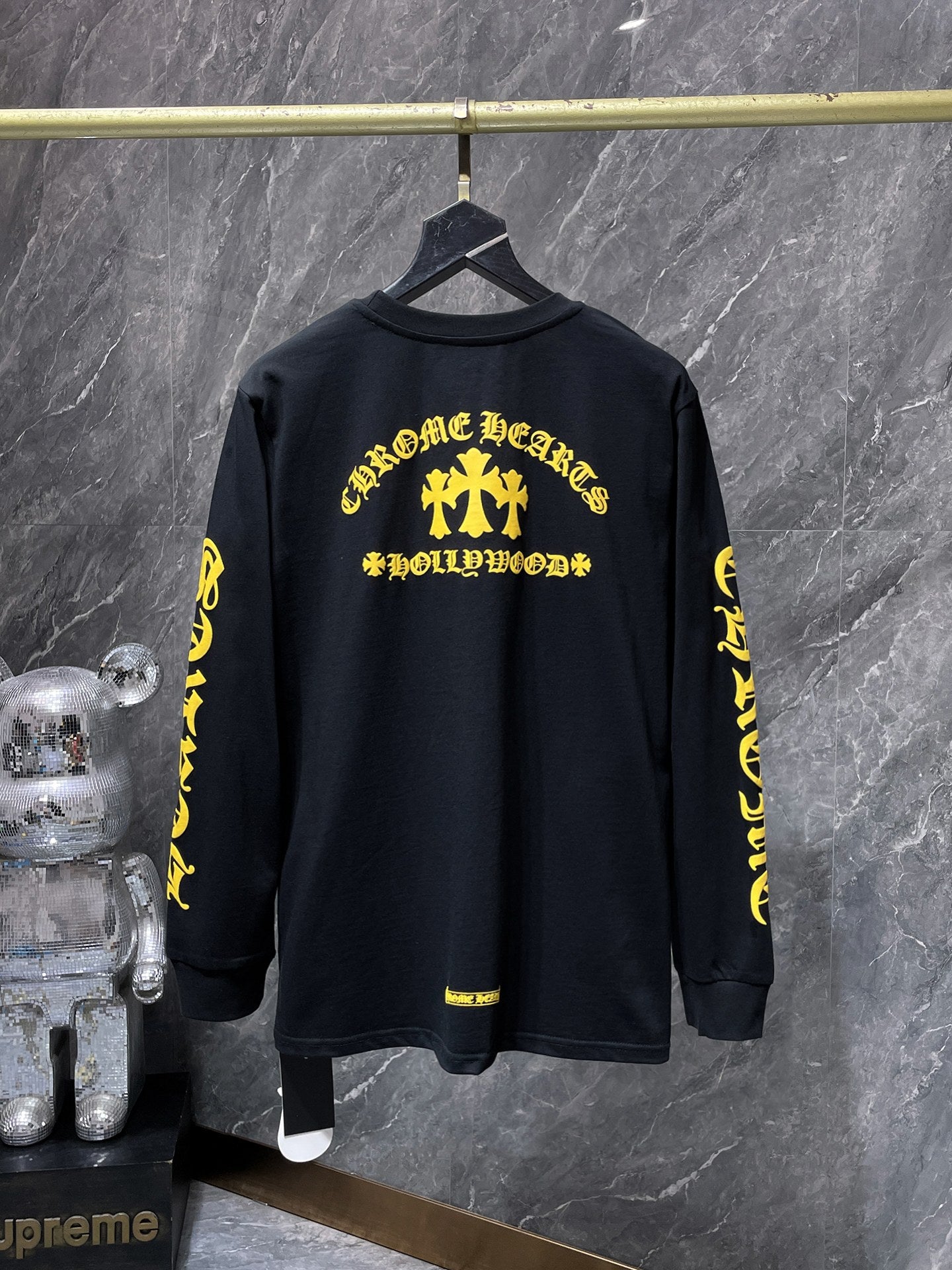 a Chrome Hearts Hollywood Triple Cross Long Sleeve T-Shirt featuring a prominent graphic on the back.